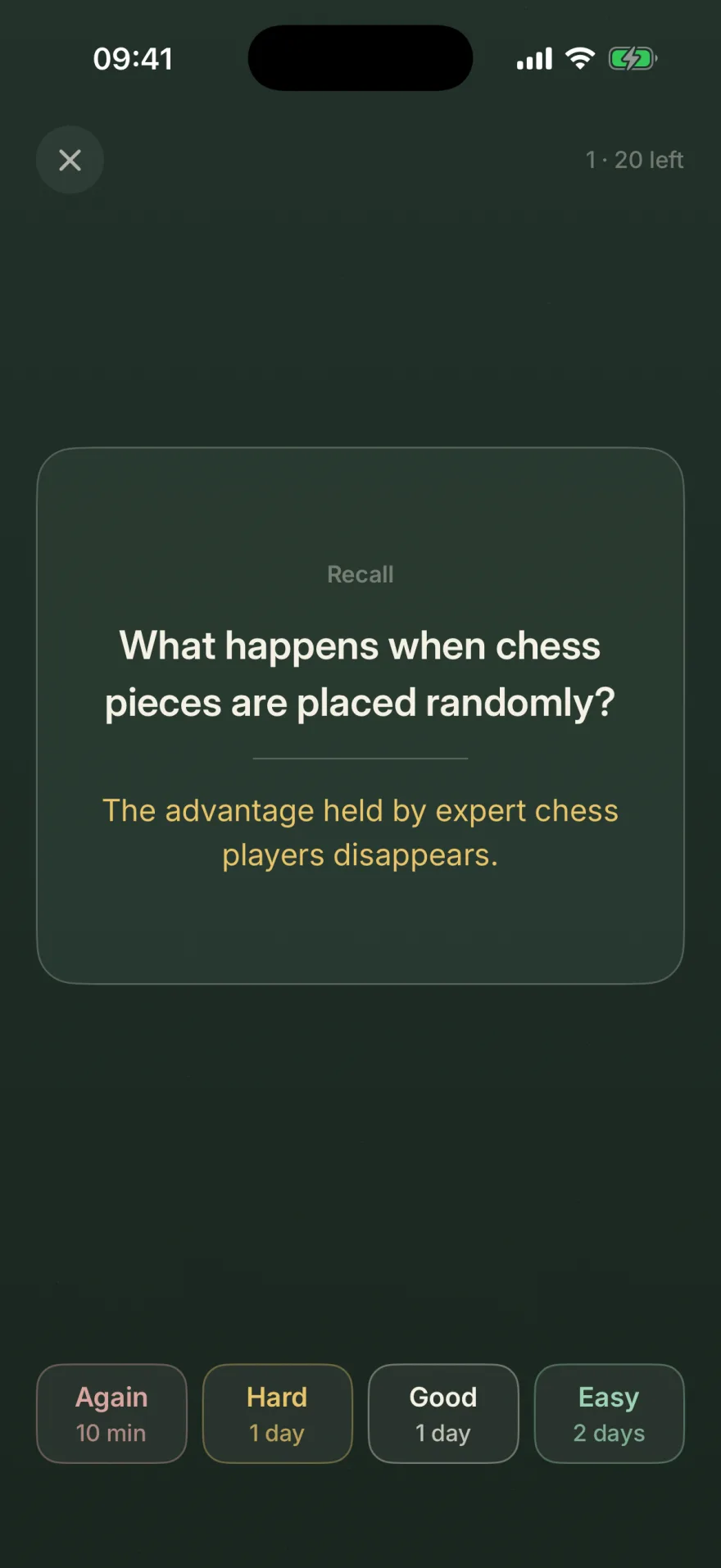 A flashcard mid-review on the blackboard: the question What happens when chess pieces are placed randomly, with its answer revealed underneath in chalk yellow — the advantage held by expert chess players disappears.